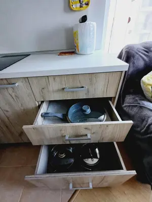 a table with a drawer with a cat in it at Guest Apartment Rusalka in Sveti Vlas
