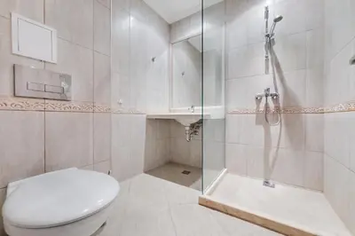 a bathroom with a toilet and a shower and a sink at АТ apartment - Pool View in Varna City