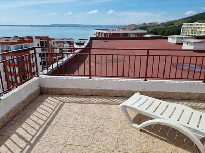 a white bench sitting on top of a roof at Roof top sea view apartment 167,2ložnice,4-7 osob in Sveti Vlas
