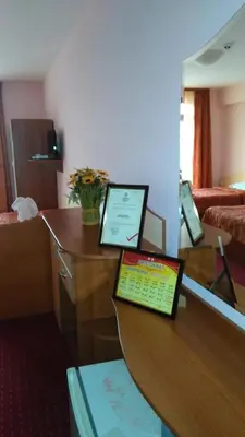 a room with a table with a laptop on it at Guest House Aristokrat in Obzor