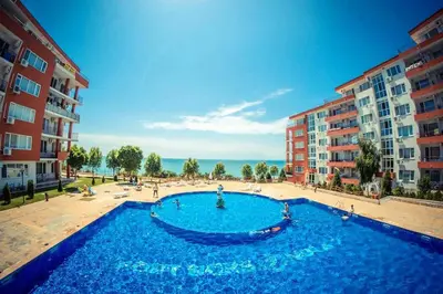 a large blue swimming pool in front of some buildings at 1kk ve Sveti Vlas in Nesebar