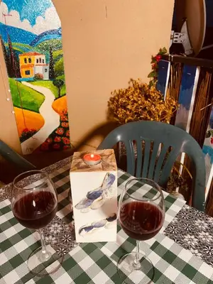 two glasses of red wine sitting on a table at Sunny view South studio Мир Авангарда in Sunny Beach