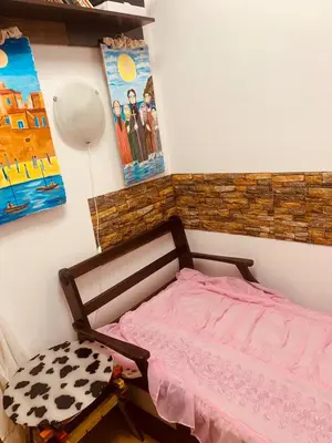 a bedroom with a pink bed and a painting at Sunny view South studio Мир Авангарда in Sunny Beach