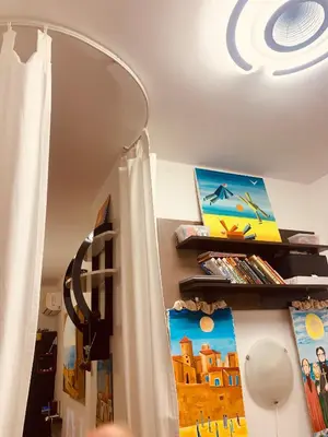 a room with a white curtain and a shelf at Студия Мир Авангарда in Sunny Beach