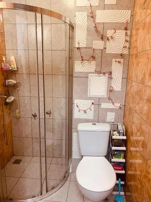 a bathroom with a toilet and a shower at Студия Мир Авангарда in Sunny Beach