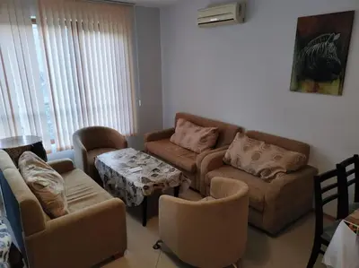 a living room with a couch and chairs and a table at Просторная квартира в популярном комплексе in Sunny Beach