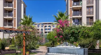 a park with a fountain in front of a building at Luxury Apartment in Cascadas Family Resort Sunny Beach in Sunny Beach