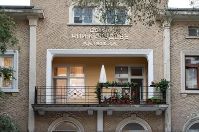 a building with a balcony with a umbrella on it at Elite place Suite in Varna City