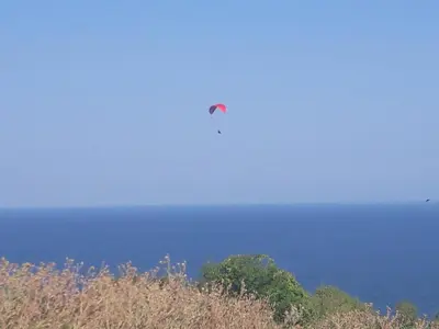 a kite flying in the sky over the ocean at Villa Byala Grape House in Byala