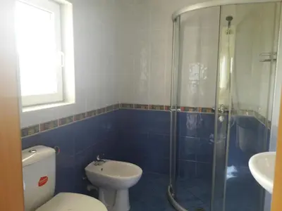 a bathroom with a shower and a toilet and a sink at Villa Byala Grape House in Byala