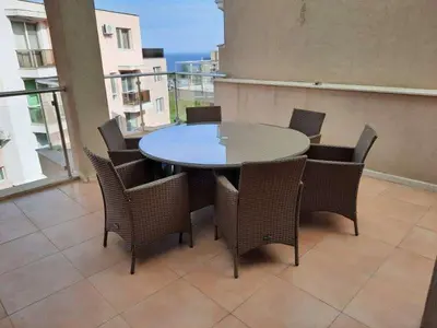 a table and chairs on top of a balcony at Sunny Villa in Byala