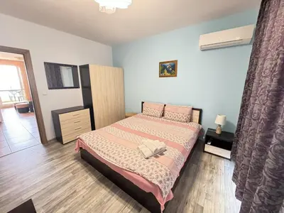 a bedroom with a bed and a dresser in it at Guest Apartment The Fabulous Sunset -Sozopol in Sozopol