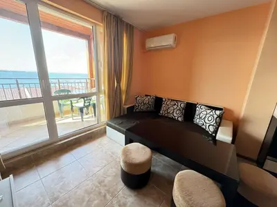 a room with a bed and a large window at Guest Apartment The Fabulous Sunset -Sozopol in Sozopol