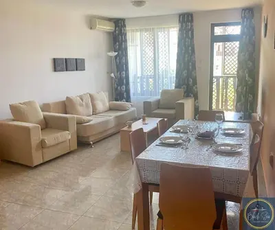 a living room with a table and a couch at 2 Bed Apt at Watermill Complex in Sveti Vlas
