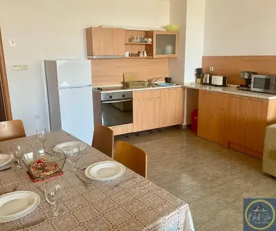 a kitchen with a table with plates on it at 2 Bed Apt at Watermill Complex in Sveti Vlas
