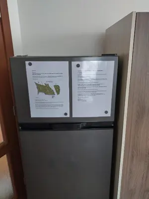 a refrigerator with two signs on top of it at Bay View Villas apartment NONA 1C - Kosharitsa in Kosharitsa