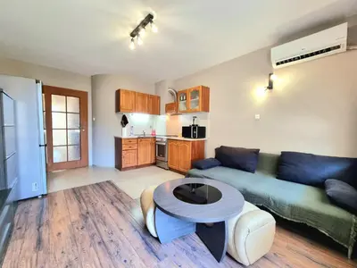 a living room with a couch and a table at Mezonet - Sol Casa in Lazur in Burgas City