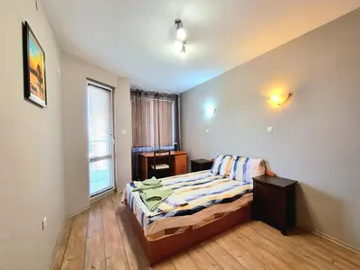 a small bedroom with a bed and a window at Mezonet - Sol Casa in Lazur in Burgas City