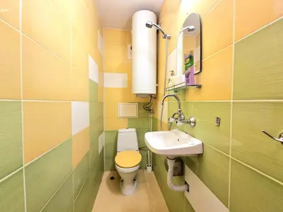 a small bathroom with a toilet and a sink at Mezonet - Sol Casa in Lazur in Burgas City