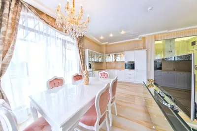 a white dining room with a white table and chairs at Harmony Suites - Monte Carlo in Sunny Beach