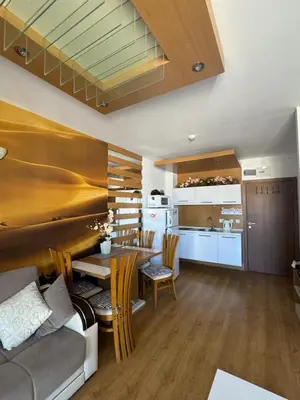 a kitchen and living room with a couch and a table at Sweet Homes 2 Apartments in Sunny Beach