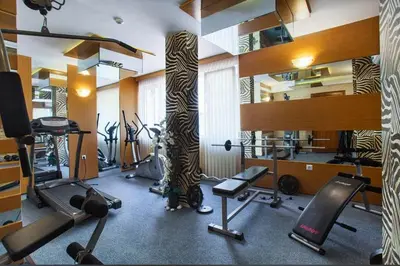 a room with a gym with a tree in the middle at Sweet Homes 2 Apartments in Sunny Beach