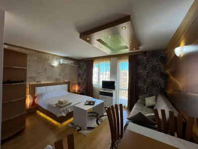 a bedroom with a bed and a living room at Sweet Homes 2 Apartments in Sunny Beach