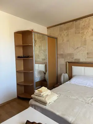 a bedroom with a bed and a book shelf at Sweet Homes 2 Apartments in Sunny Beach