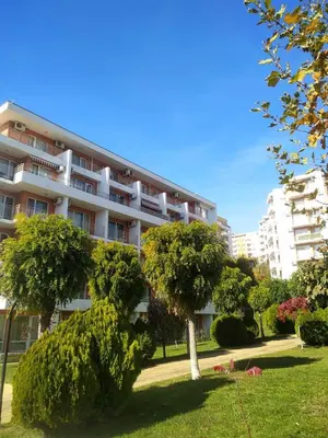 an apartment building with trees in front of it at Aria private apartments in Fort Noks Grand Resort - Saint Vlas in Elenite
