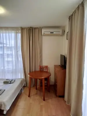 a small room with a table and a bed and a window at Aria private apartments in Fort Noks Grand Resort - Saint Vlas in Elenite