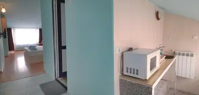 a kitchen with a white microwave on a counter at Hotel Bobchev in Sozopol