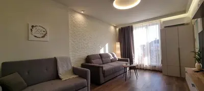 a living room with a couch and a chair at Kate`s Place in Burgas City