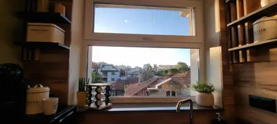 a kitchen window with a view of a city at Kate`s Place in Burgas City