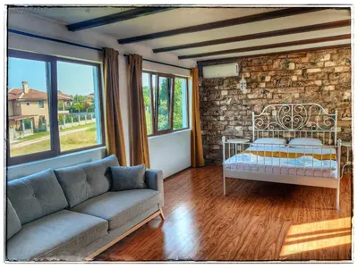 a living room with a bed and a couch at Casa Alegra in Bliznatsi