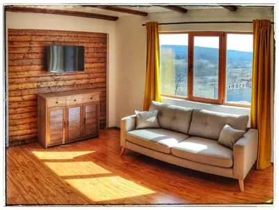 a living room with a couch and a window at Casa Alegra in Bliznatsi