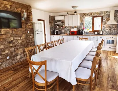 a kitchen with a dining room table and chairs at Casa Alegra in Bliznatsi