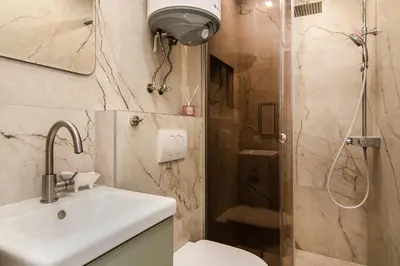 a bathroom with a shower and a sink and a toilet at Tiny studio in center of Varna in Varna City