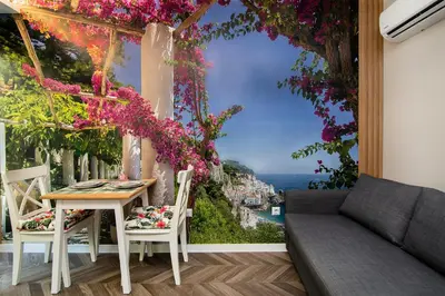 a balcony with a view of the city and flowers wallpaper at Tiny studio in center of Varna in Varna City