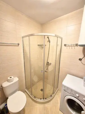 a shower in a bathroom with a toilet and a washing machine at Attractive Apartment in Sunny Beach Cascadas Family Resort in Sunny Beach