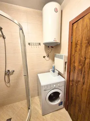 a bathroom with a washing machine and a shower at Attractive Apartment in Sunny Beach Cascadas Family Resort in Sunny Beach