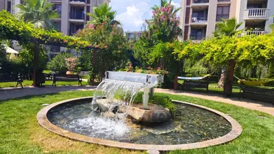 a fountain in a park in front of a building at Attractive Apartment in Sunny Beach Cascadas Family Resort in Sunny Beach