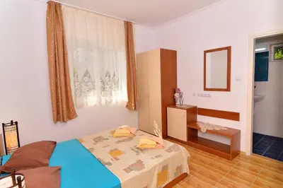 a bedroom with a bed and a mirror in it at BulgariaVilla - Royal Villas in Bryastovets
