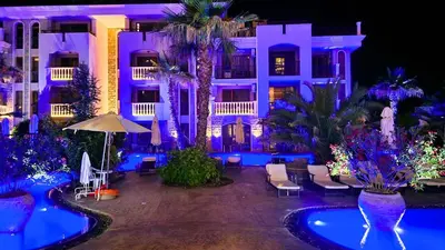 a hotel with blue lighting in front of a building at Attractive Studio-Apartment in Sunny Beach Cascadas Family Resort in Sunny Beach