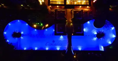 a blue lighted sign in front of a building at Attractive Studio-Apartment in Sunny Beach Cascadas Family Resort in Sunny Beach