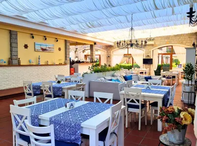 a restaurant with blue and white tables and chairs at Attractive Studio-Apartment in Sunny Beach Cascadas Family Resort in Sunny Beach