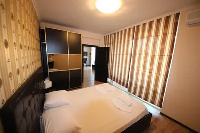 a bedroom with a bed and a large window at Menada Dune Residence Apartments in Sunny Beach