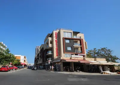 a building on the side of a city street at Menada Dune Residence Apartments in Sunny Beach