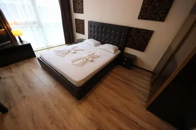 a bedroom with a bed with two bows on it at Menada Dune Residence Apartments in Sunny Beach