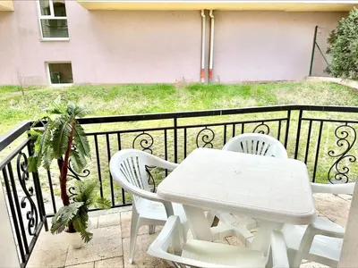 a white table and chairs on a balcony at Menada Romance Marine Apartments in Sunny Beach