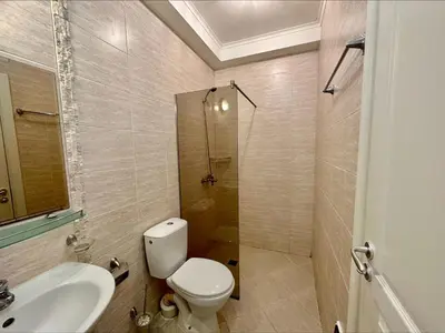 a bathroom with a toilet and a shower and a sink at Menada Romance Marine Apartments in Sunny Beach